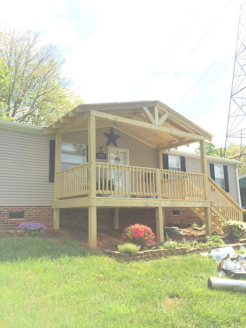 New gabled porch roof and deck railing added to a ranch home in South Hutchinson
